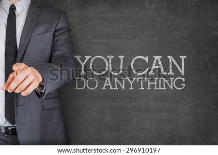You can do anything on blackboard with businessman finger pointing