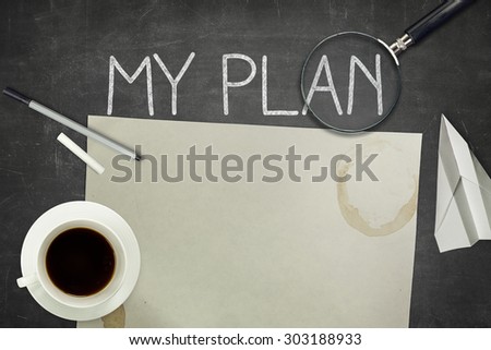 My plan concept on black blackboard with magnifying glass, empty paper sheet and coffee cup
