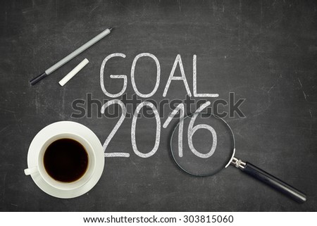 Goal 2016 concept on black blackboard with empty paper sheet and coffee cup