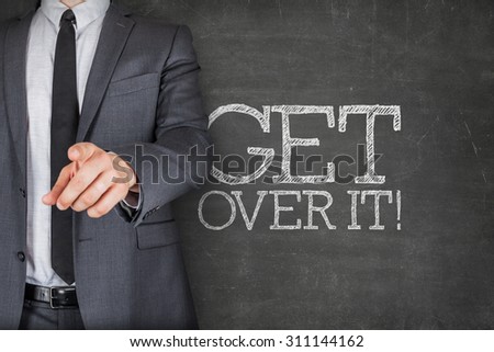 Get over it on blackboard with businessman finger pointing