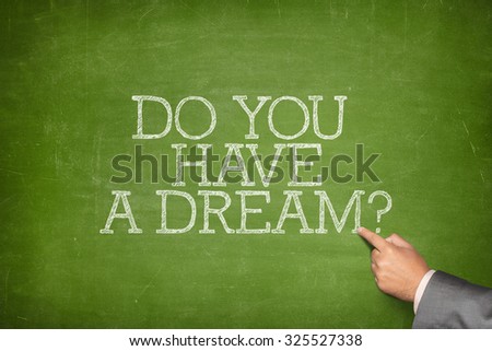 Do you have a dream text on blackboard with businessman hand pointing