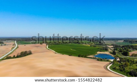 Similar – Image, Stock Photo Landscape shot of a quiet lake surrounded by trees and bushes, reflecting the blue sky in autumn