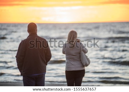 Photo of Jurmala, Latvia. Sunset at the Baltc sea. Man and woman at sunset