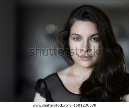Photo of Portrait of pretty woman dark hair, blue eyes. Womans face. portrait of beautiful woman. portrait of young woman.