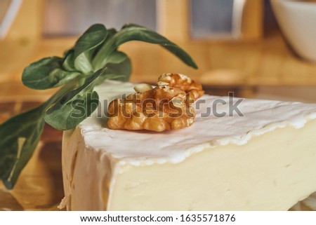 Cheese peaces on the old wooden table in the kitchen. Dairy product. Healthy eating and lifestyle. Stok fotoğraf © 