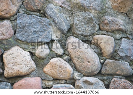 Texture of a stone wall. Old castle stone wall texture background. Stone wall as a background or texture. Part of a stone wall, for background or texture. Сток-фото © 