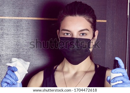 Photo of Coronavirus. Woman in quarantine for coronavirus wearing protective mask and plastic gloves.