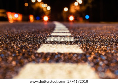 asphalt road leading into the city at night. Selective focus. background
