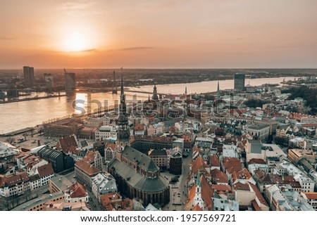 Photo of RIga rooftop view panorama at sunset with urban architectures and Daugava River. View of the old town