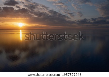 Early morning sunrise over the sea . Some clouds. Сток-фото © 