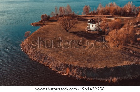 View on red holiday cabin by a lake in Stockholm archipelago, Sweden. Wooden cottage, sauna on shore. Tiny house near the water. Rocky small island, islet in water. Buildings surrounded by green trees Foto d'archivio © 