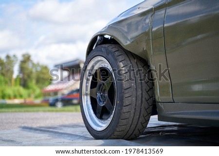 Rear side view front wheel of black car