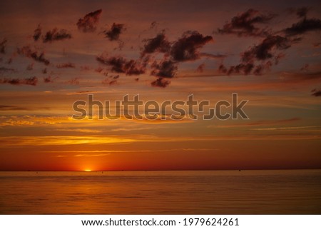 Dramatic sunset sky with clouds. Dramatic sunset over the sea