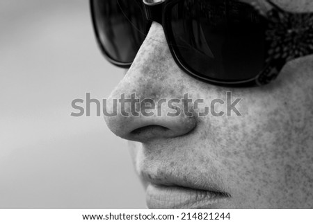 Woman with Freckles and Sunglasses Sweating in the Summer Sun (Black and White)