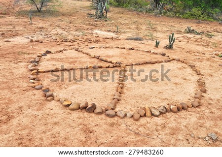 A peace sign made out of rocks