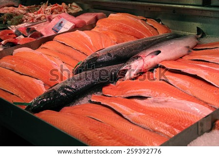 The big pieces of salmons on ice in the fish market