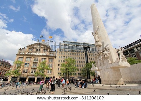 AMSTERDAM, THE NETHERLANDS - May 31: People near the Dutch National War Memorial at central plaza De Dam on May 31, 2011