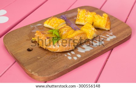 french toast with butter and milk on Wooden pink background