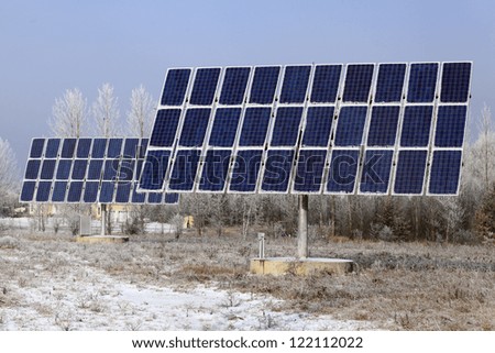 Solar Photovoltaic Panels In A Rural Residential Area Covered With Ice In Winter