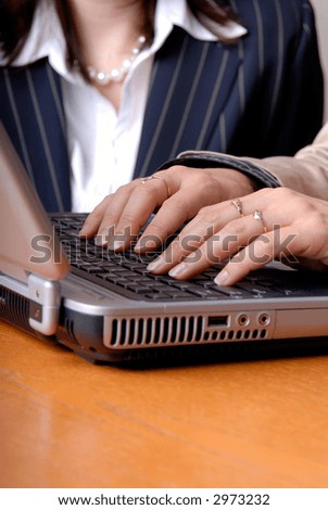 Woman Typing On The Keyboard Of A Laptop Computer