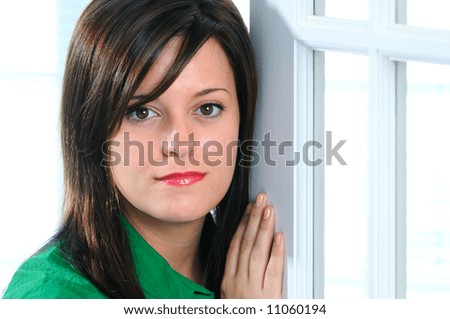 Woman Leaning On A French Door In Her Home