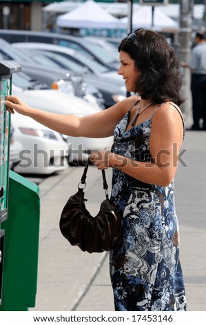 Woman Putting Money In A Parking Ticket Machine