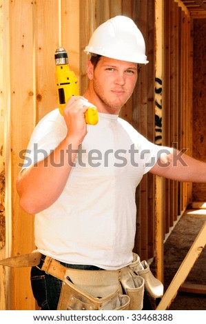 Framing Contractor Inside A New Home Holding A Power Drill