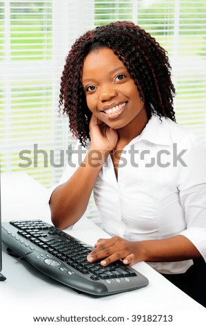 Beautiful Female African American Call Center Agent Wearing A Telephone Headset Using A Computer r