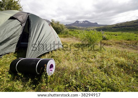Tent and foam mattress in beautiful mountain region. Camping in wild