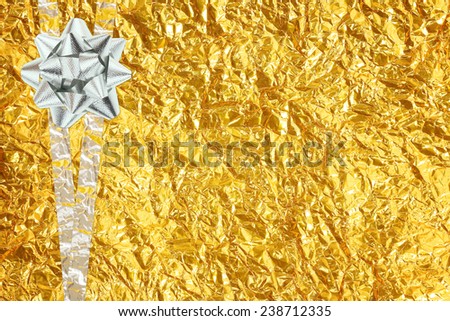 Shiny yellow leaf gold and  silver ribbon on Shiny foil texture background