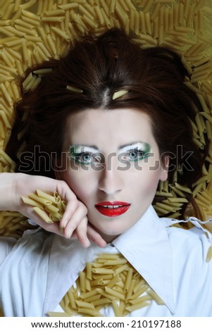 Close up face with make up in Italian colors on the pasta background