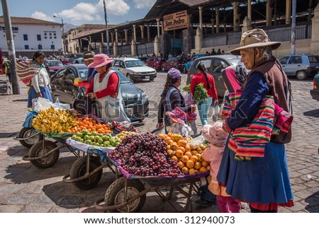 CUZCO, PERU - CIRCA 2015: Fruit sellers in the street circa 2015 in Cuzco, Peru.