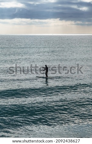 Similar – Image, Stock Photo Unrecognizable athlete practicing surfing on ocean wave