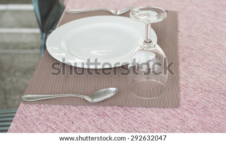 Empty plate, glasses and silverware set