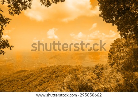 Mountain forest landscape on rainbow sky . Filtered image: Soft and vintage effect.
