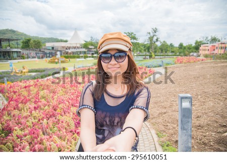 NAKORNRACHASRIMA, THAILAND - JUNE 27 : The girl travel in the garden flower at the bloom tv pool on JUNE 27, 2015 in Nakornrachasrima, Thailand