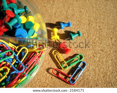 Colorful clips and pins in a box and on card board