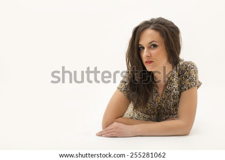 portrait of a beautiful lady lying down on her belly isolated