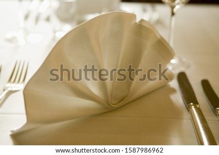 Close up of fancy napkin at place setting on table