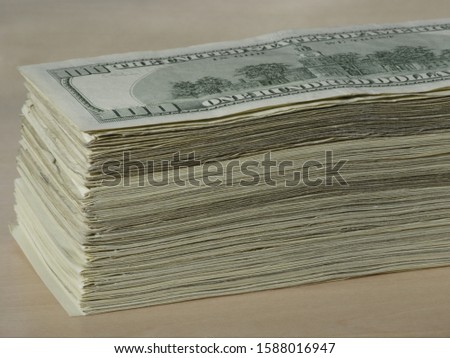 Close up of stack of US one hundred dollar bills