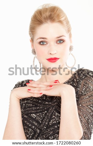 Glamorous young woman hands clasped, portrait
