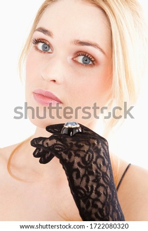 Glamorous young woman wearing ring on lace glove
