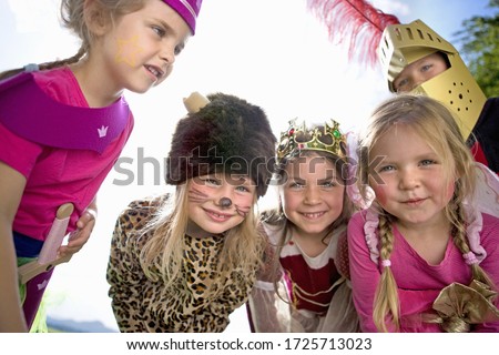 Kindergarten children in costume playing in a wood kindergarten