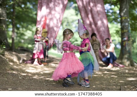 Kindergarten children in costume staging a play in a wood kindergarten