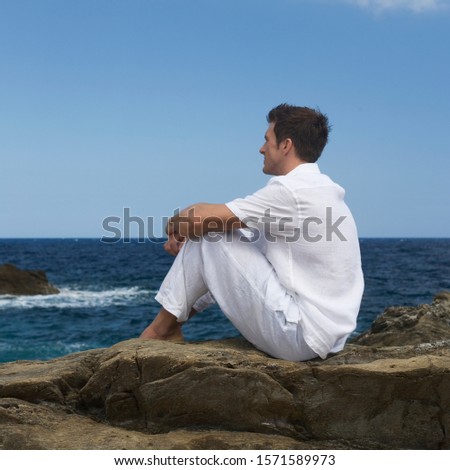 A man sitting by the sea Foto d'archivio © 