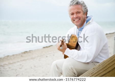 A senior man playing a guitar Stok fotoğraf © 