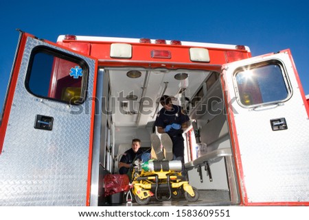 EMTs waiting in a sports program