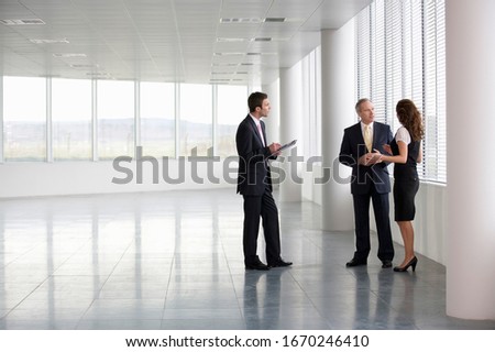 A letting agent showing businesspeople around an empty office Stock fotó © 