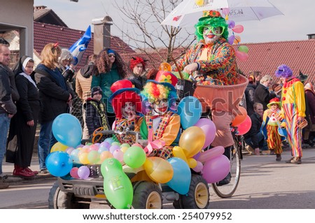VIR PRI DOMZALAH, SLOVENIA - FEBRUARY 15, 2015: Clowns, carnival mask. They cycling through the people.