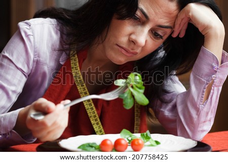 Young woman bored of dieting . Selective focus on her face.